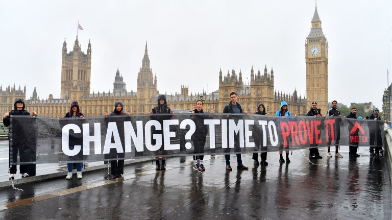 Shelter activists hold up banner targeting Keir Starmer which reads: 