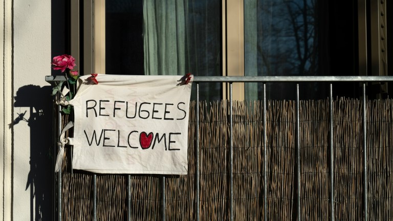 A Refugees Welcome sign on a fence